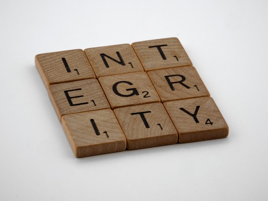 a scrabbled wooden block with the words integr city on it